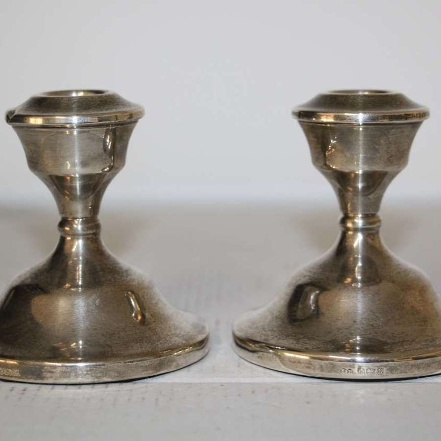 A pair of dwarf candle sticks.8cm ht 8cm wide.Total weight of 240grams