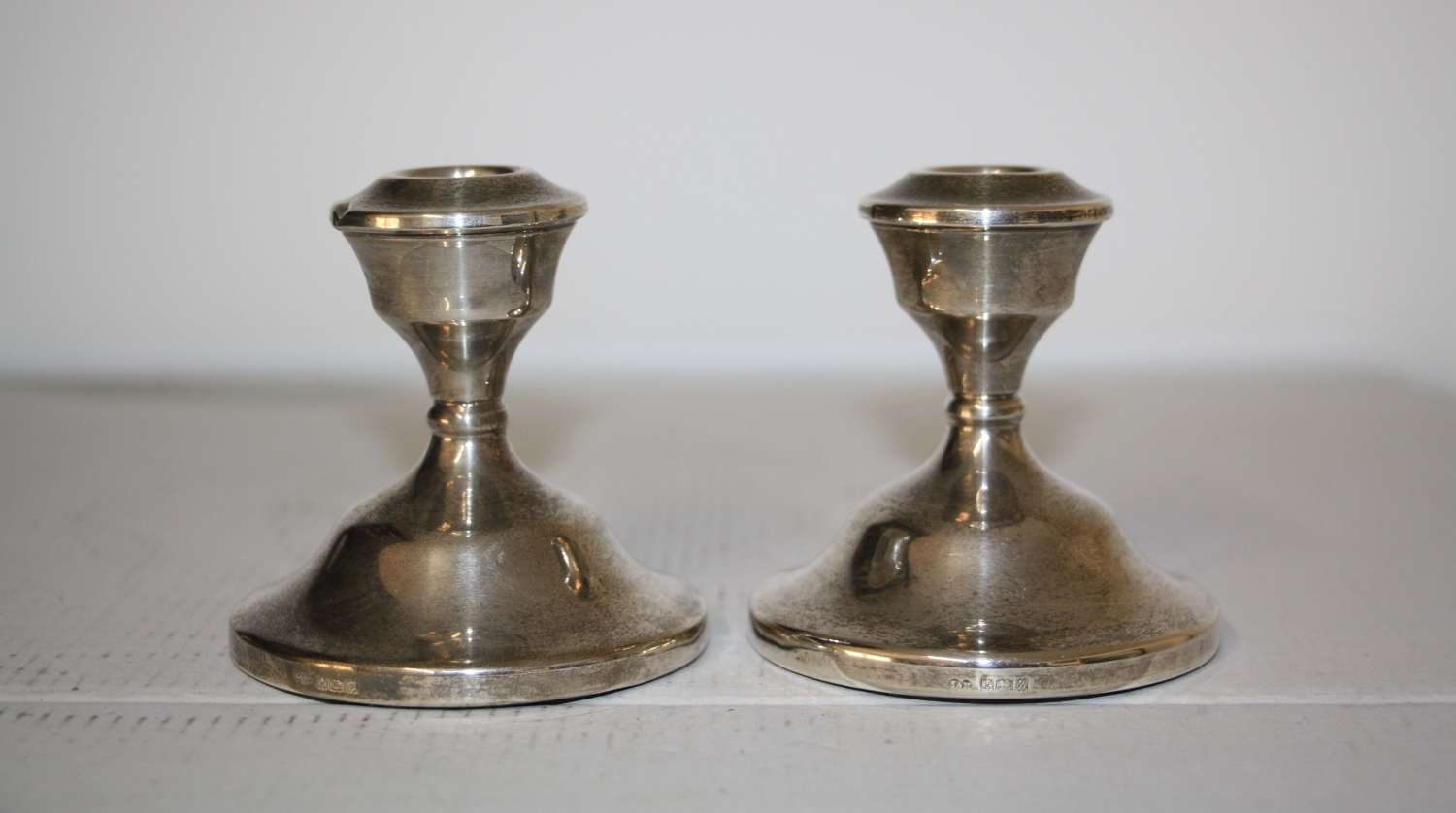 A pair of dwarf candle sticks.8cm ht 8cm wide.Total weight of 240grams