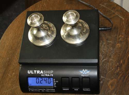 A pair of dwarf candle sticks.8cm ht 8cm wide.Total weight of 240grams