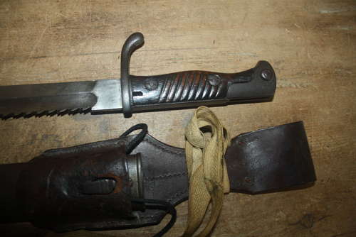 A WW1 GERMAN SAWBACK BUTCHER BAYONET.WITH ORIGINAL FROG AND KNOT.