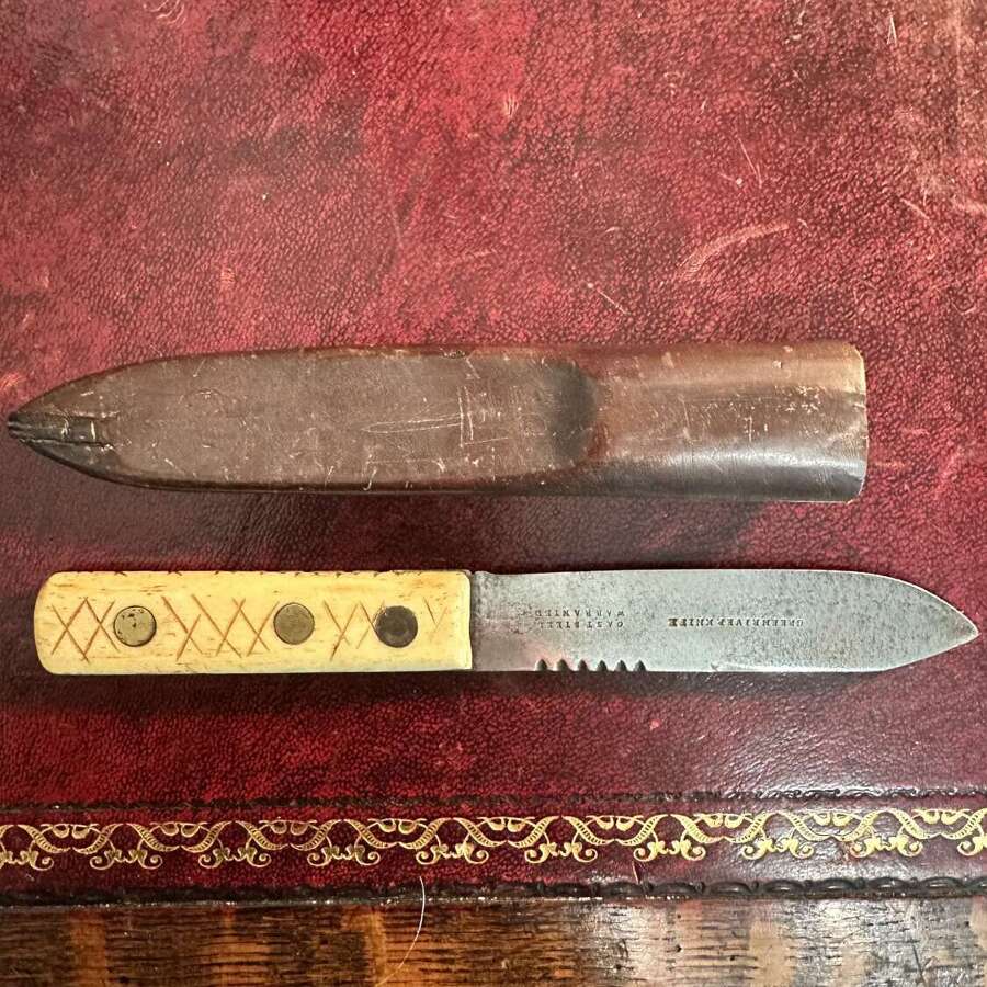 A 19th century green river hunting knife. In leather scabbard.