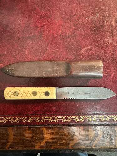 A 19th century green river hunting knife. In leather scabbard.