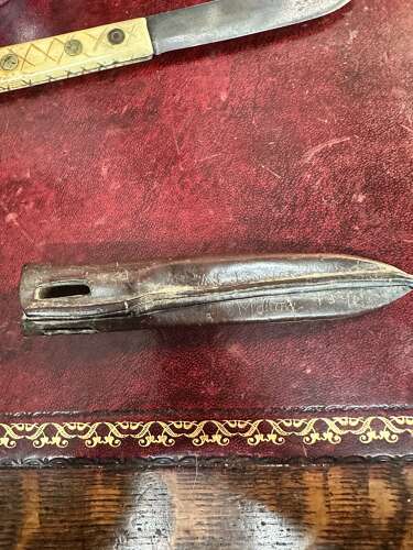 A 19th century green river hunting knife. In leather scabbard.